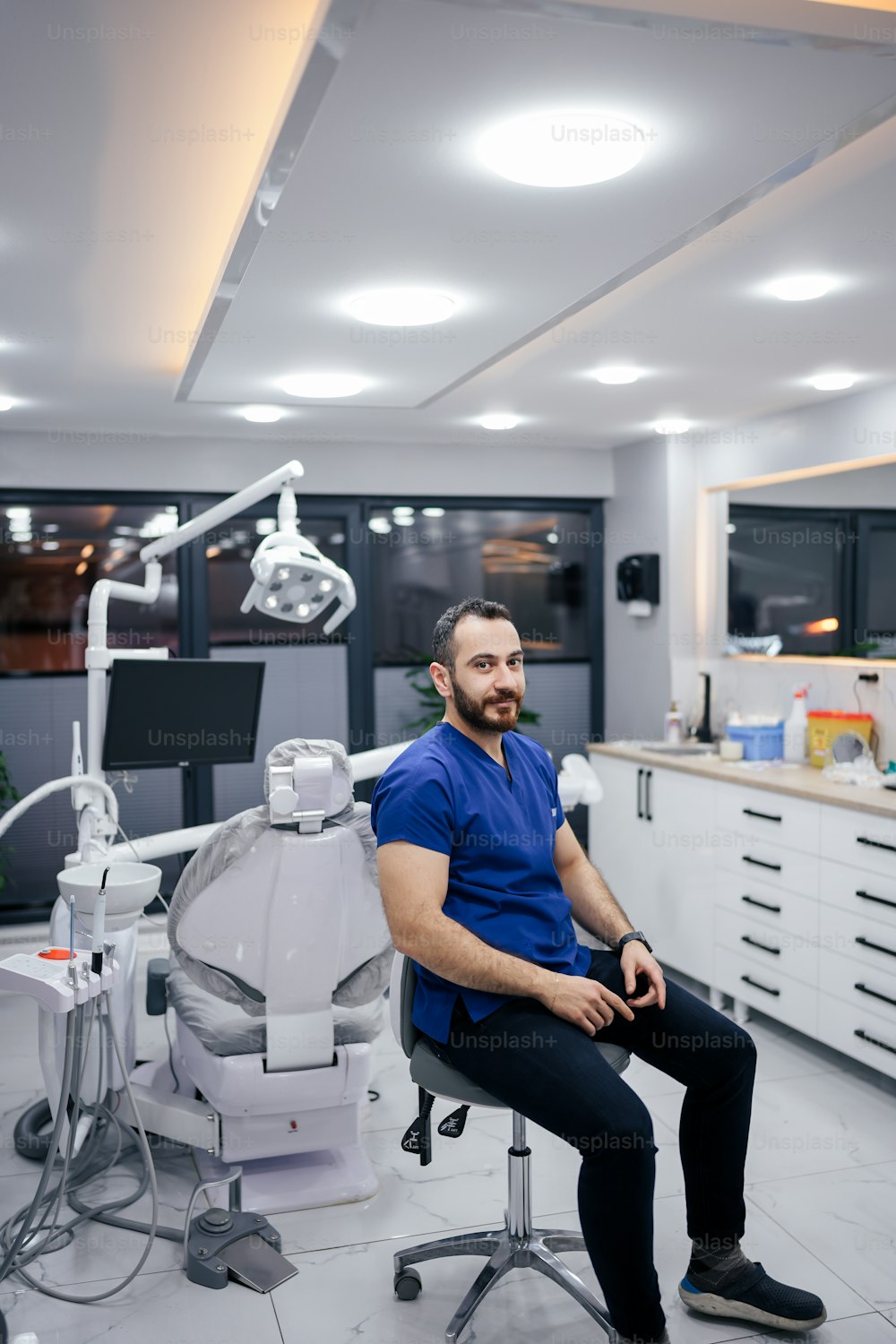 a man sitting on a chair in a dental room