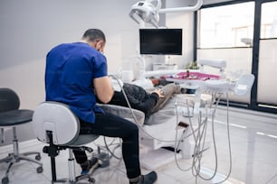 a man sitting in a chair in a dental office