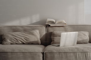 a laptop computer sitting on top of a couch