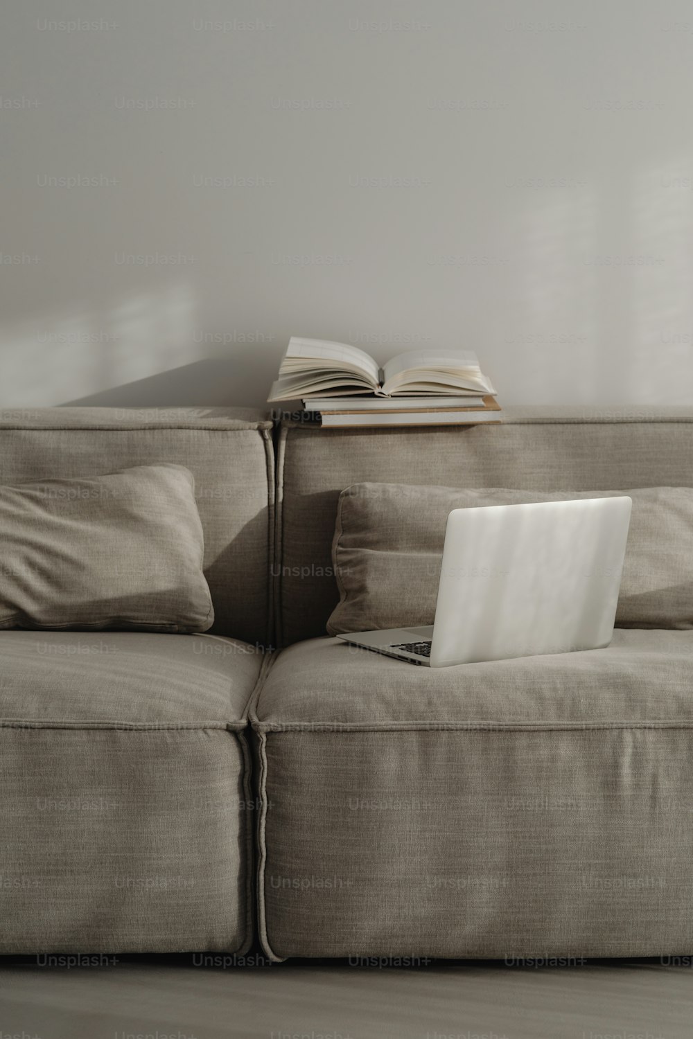 a laptop computer sitting on top of a couch