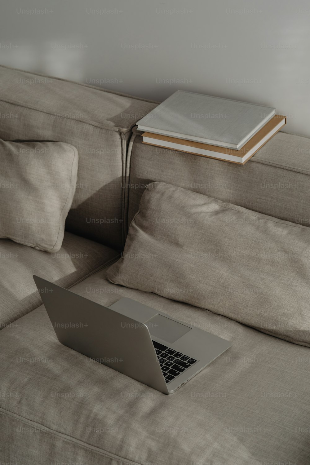 a laptop computer sitting on top of a couch