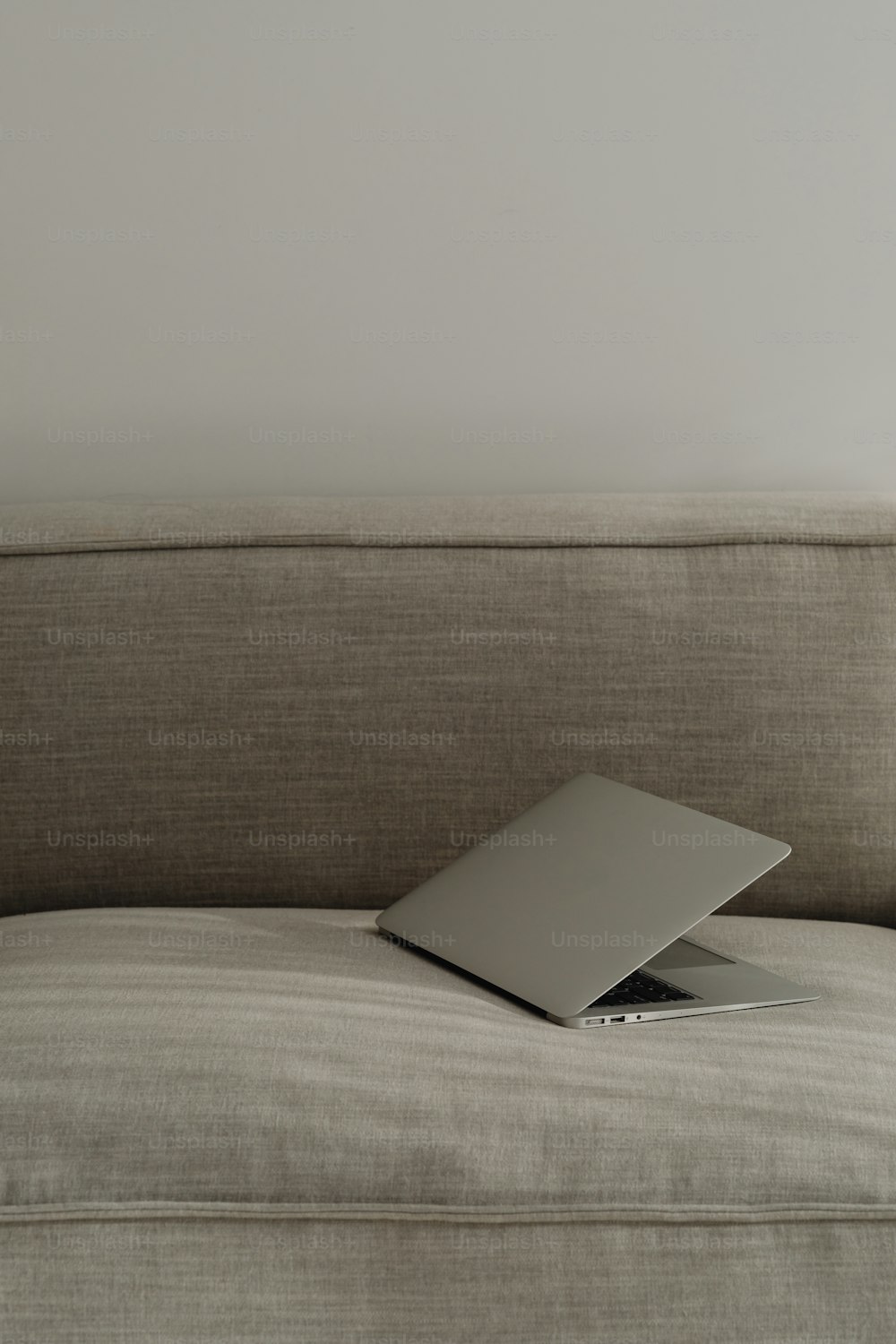 a laptop computer sitting on top of a couch