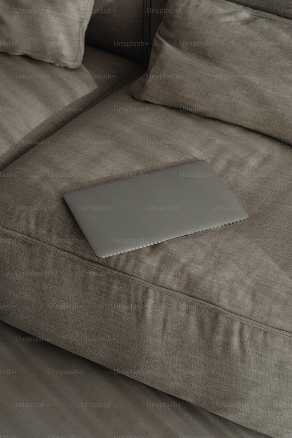 a laptop computer sitting on top of a couch