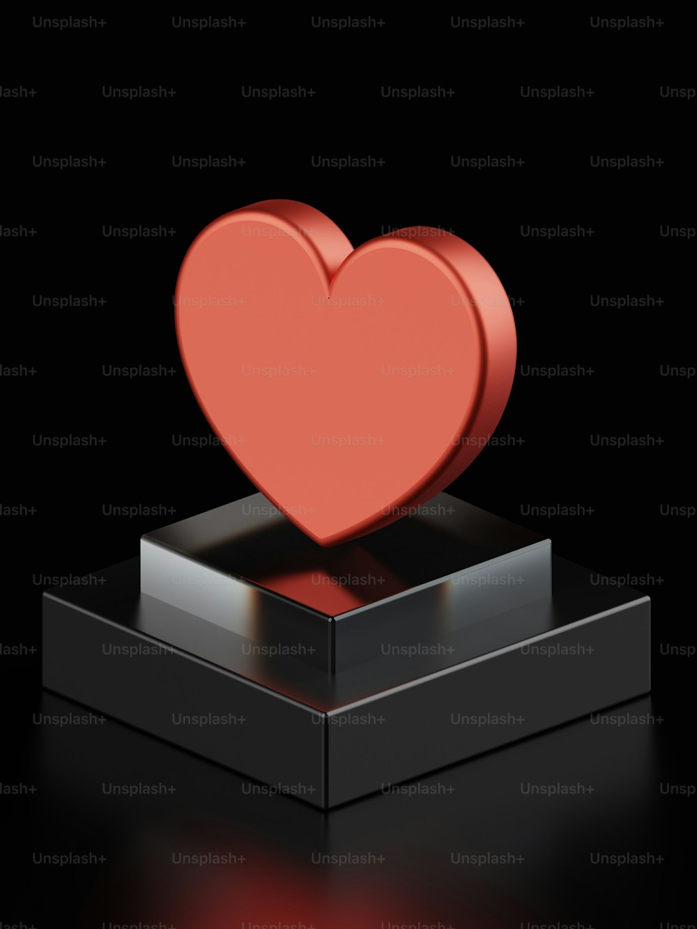 um coração vermelho sentado em cima de uma caixa preta