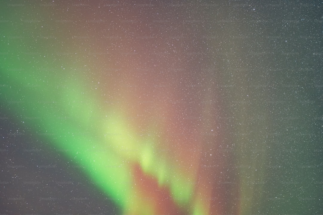 a bright green and red aurora bore in the sky