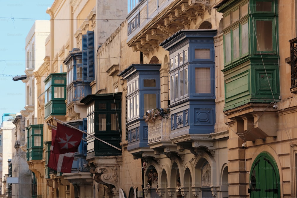 a row of buildings with balconies and a flag