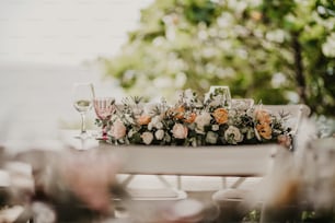 a table with flowers and wine glasses on it