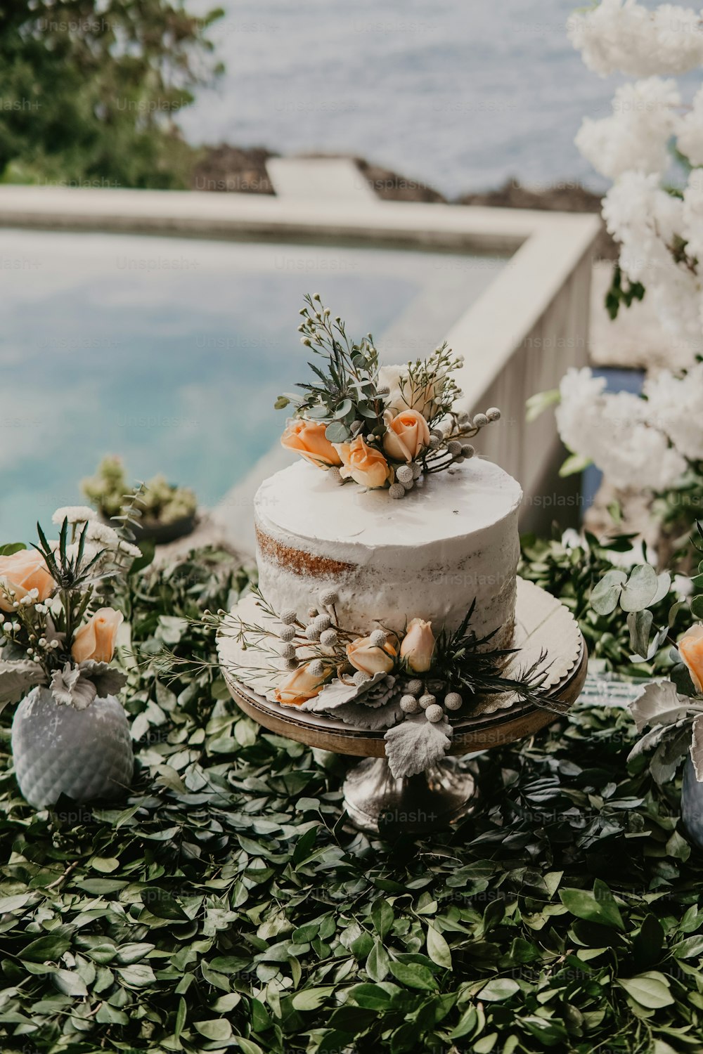 a wedding cake sitting on top of a lush green field
