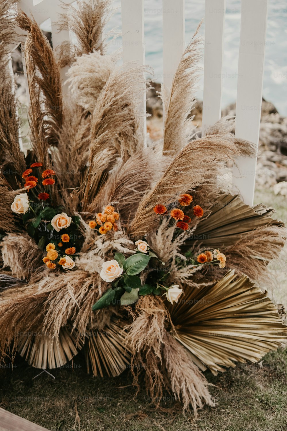 a bouquet of flowers sitting on top of a grass covered ground