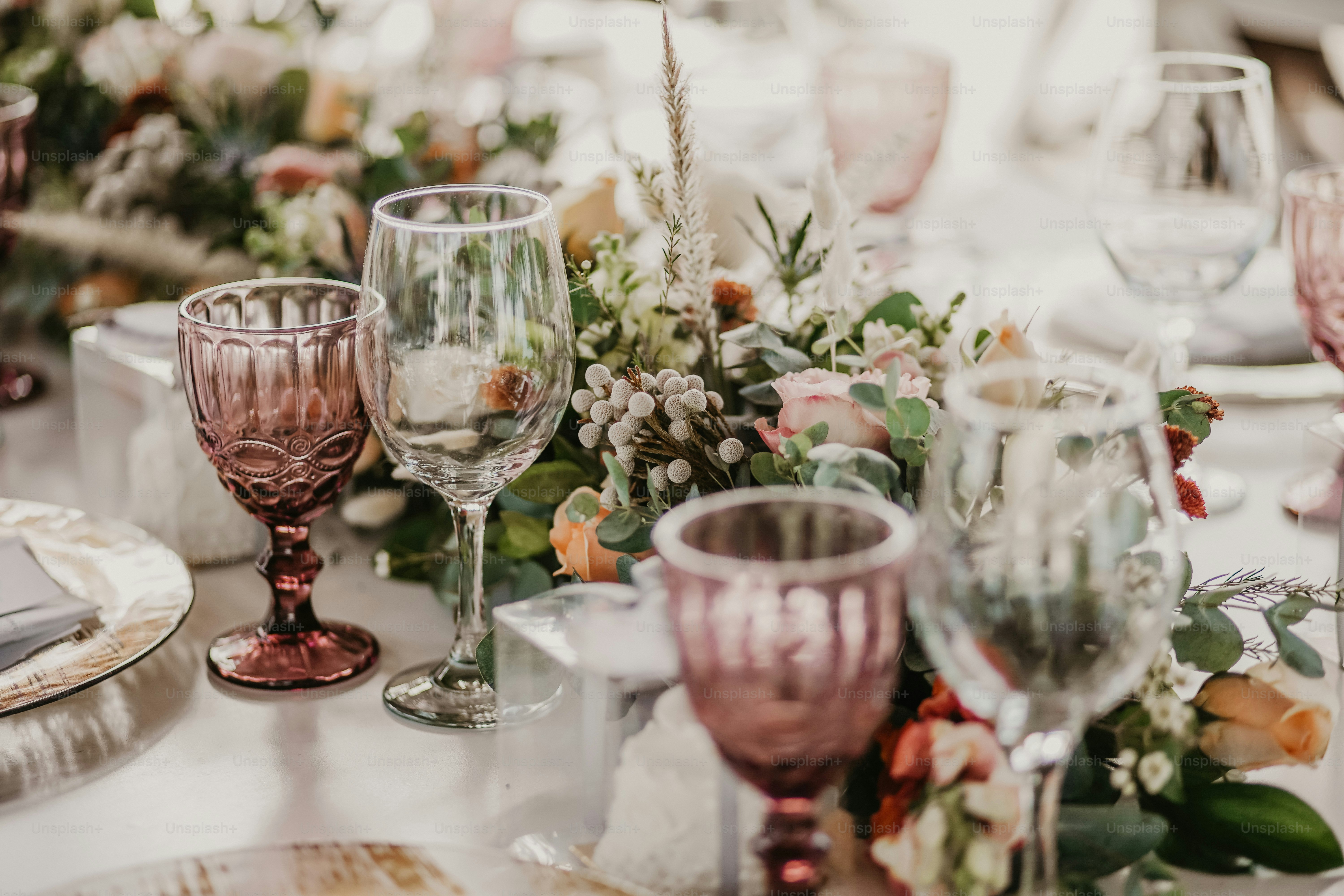 a close up of a table with glasses and flowers