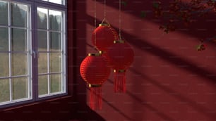 three red lanterns hanging from a red wall
