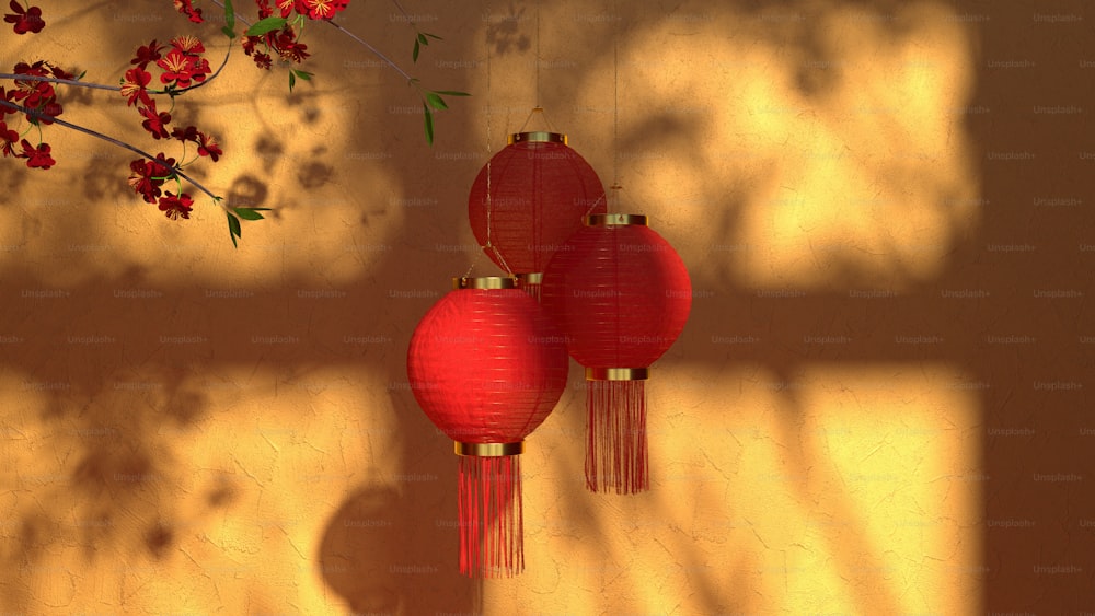 three red paper lanterns hanging from a wall