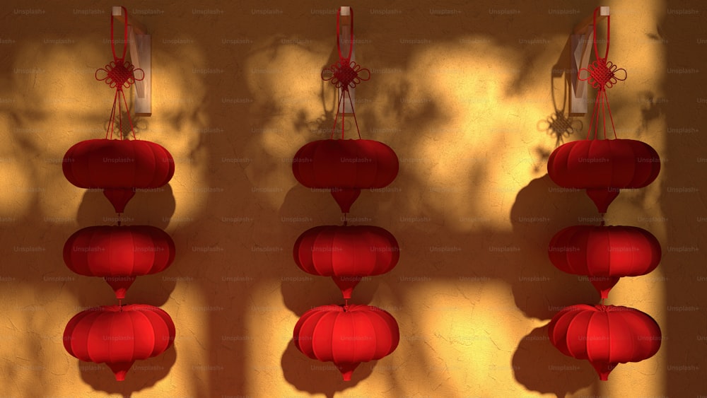 three red lanterns are hanging on a wall