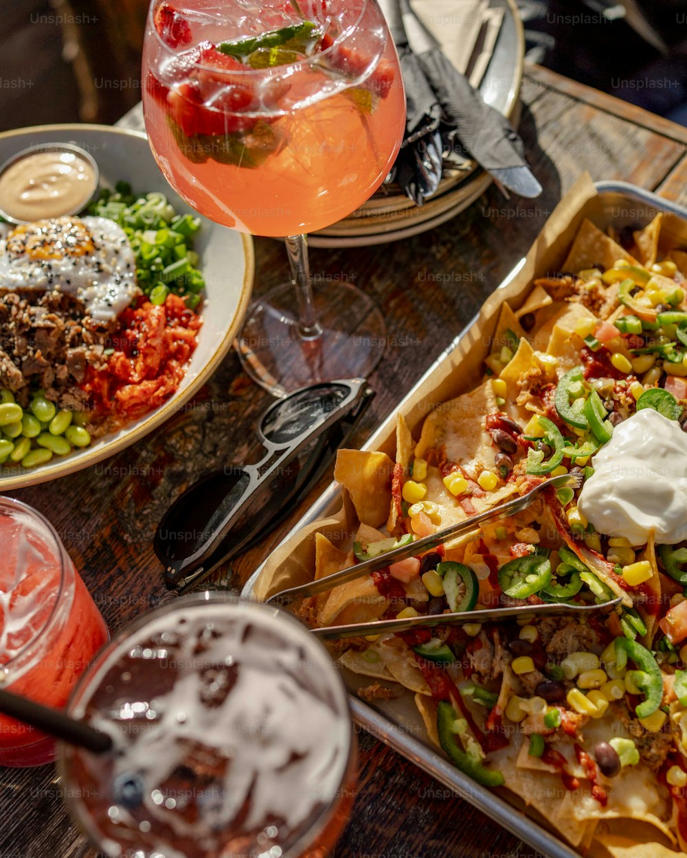 a table topped with plates of food and drinks