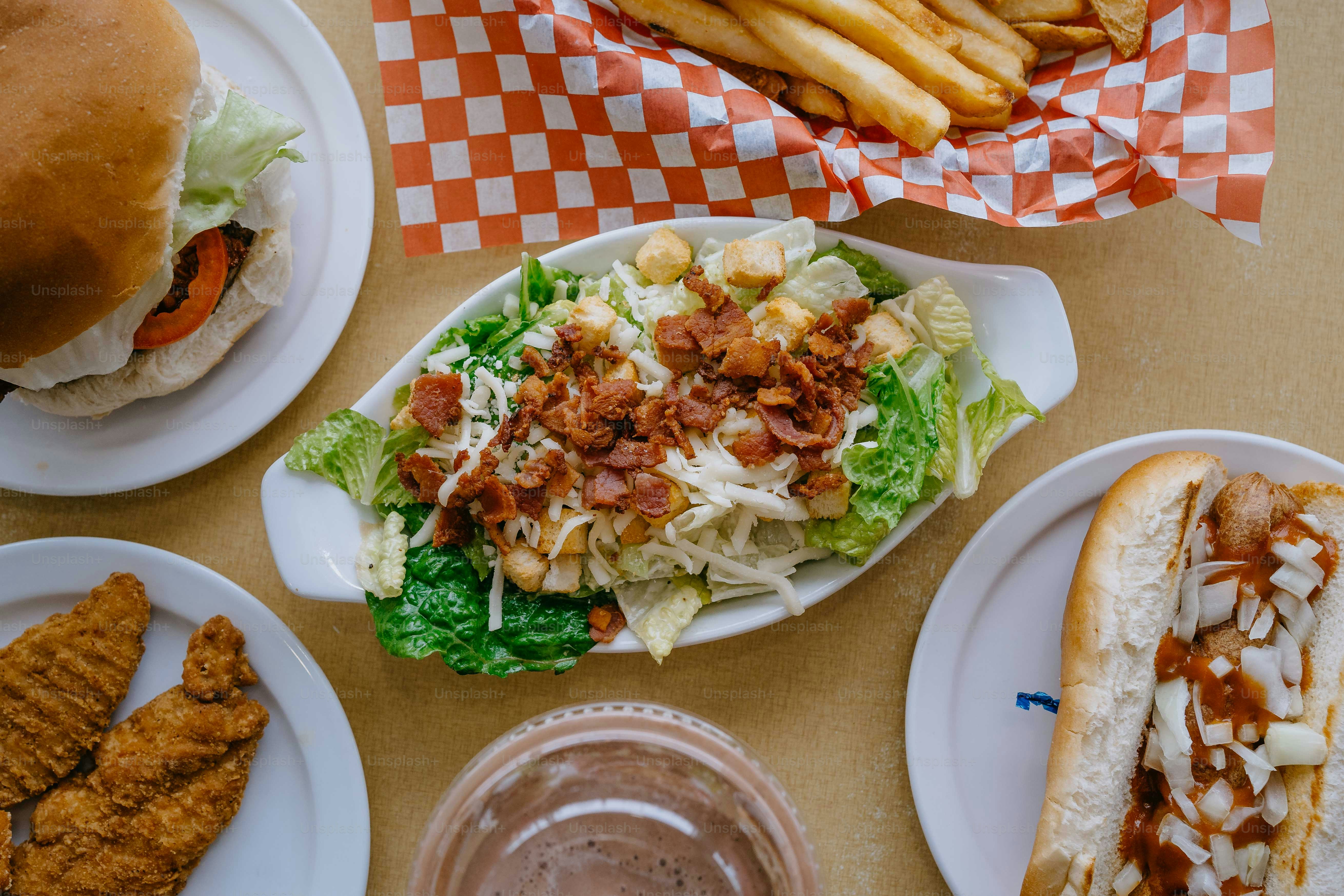 a table topped with plates of food and french fries