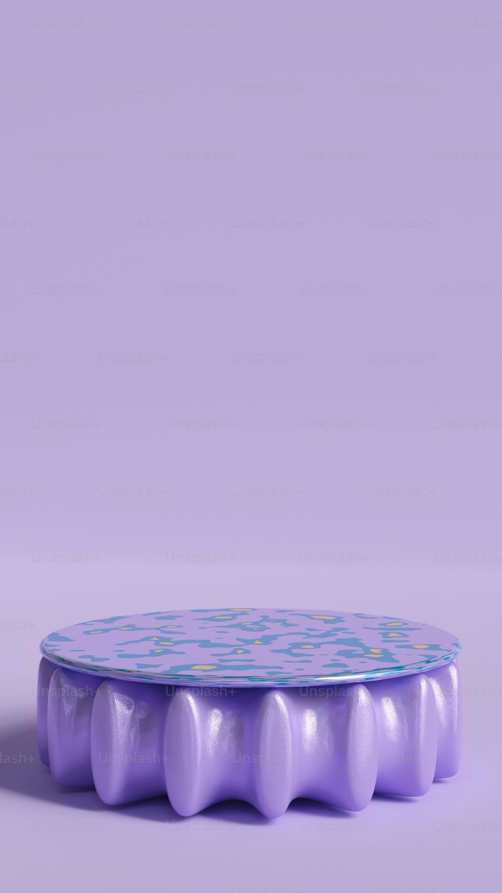 a purple and blue cake sitting on top of a table