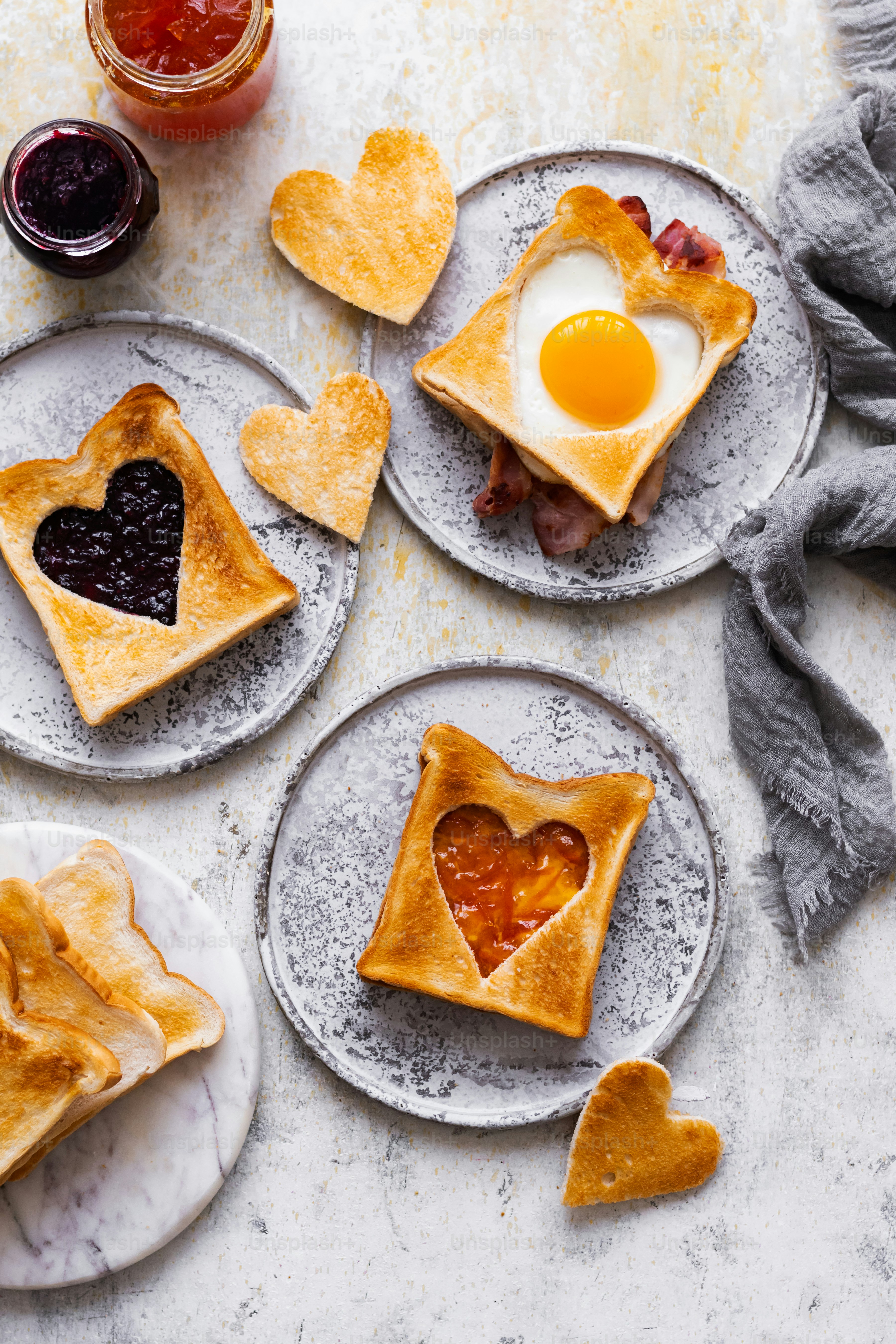 a table topped with plates of heart shaped pastries