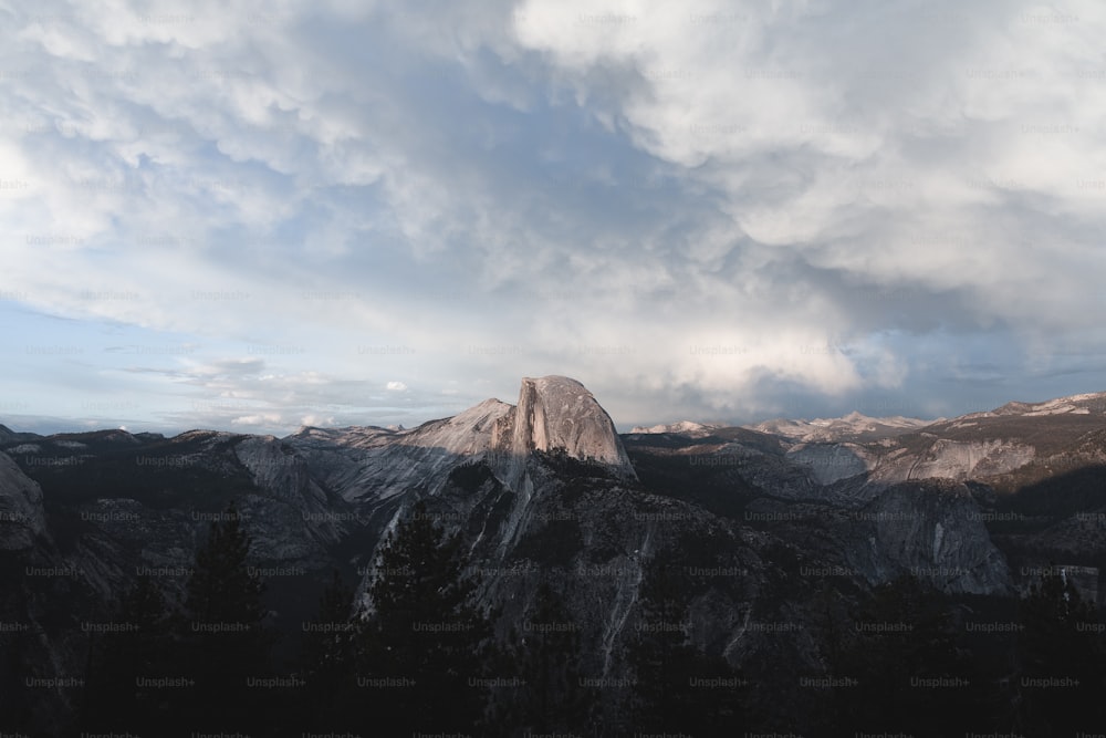 Una vista della cima di una montagna con le nuvole nel cielo