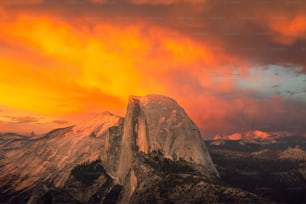 a very tall mountain with a very colorful sky in the background