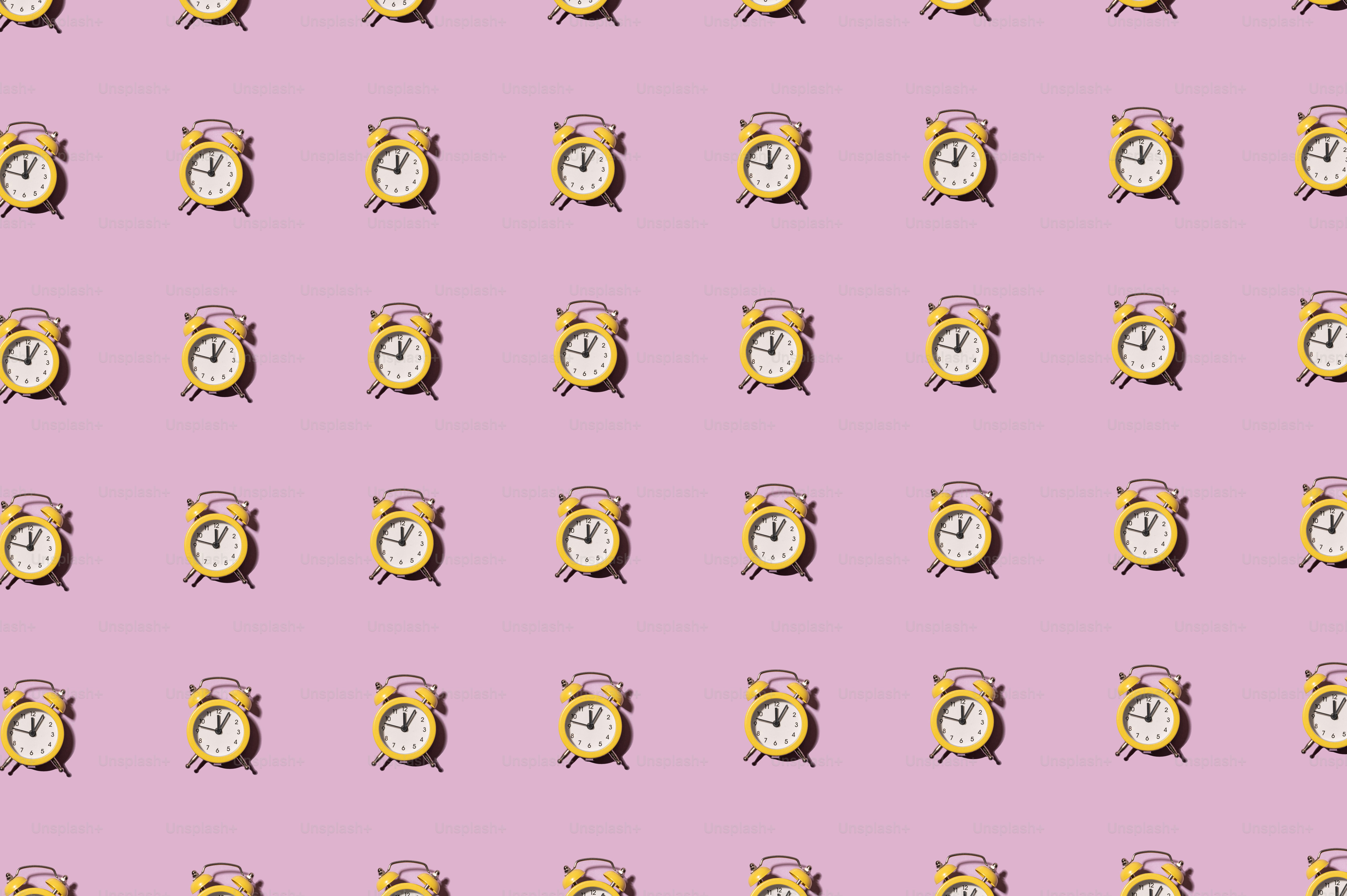 a pattern of an alarm clock on a pink background