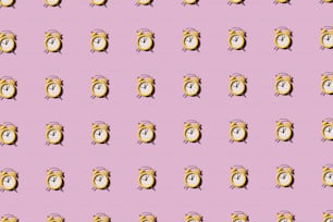 a pattern of an alarm clock on a pink background