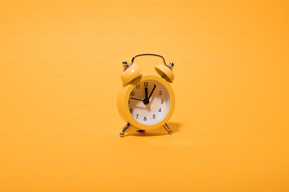 a yellow alarm clock on a yellow background