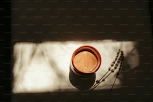 a cup of coffee sitting on top of a table