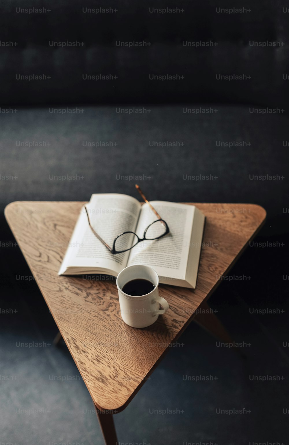 a table with a book and a cup of coffee on it