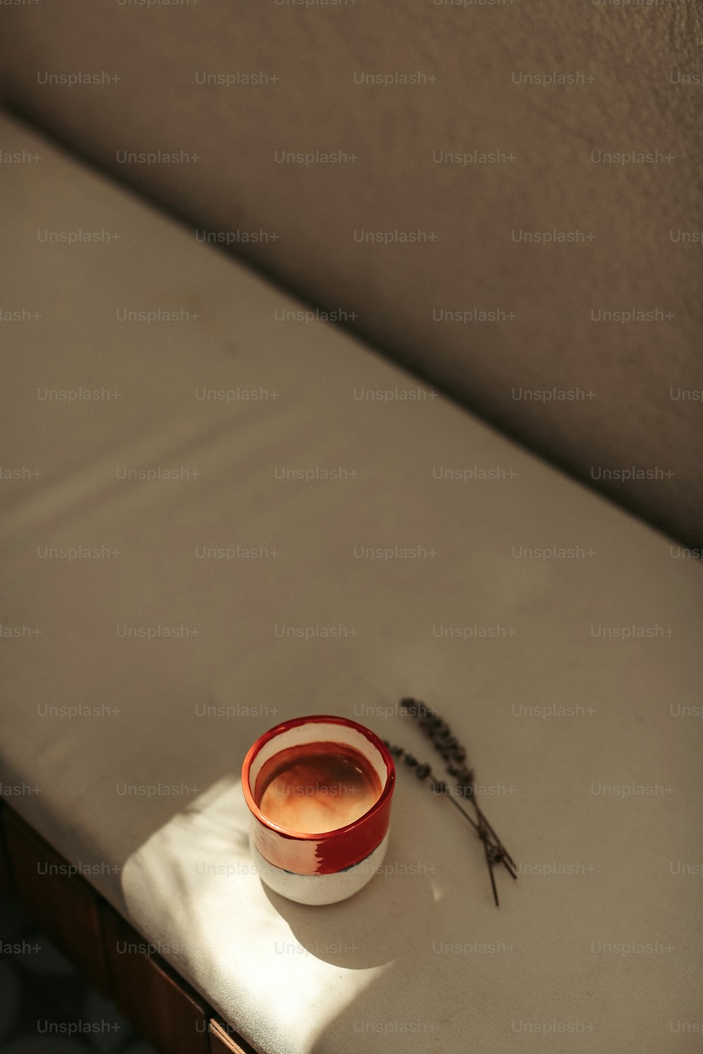 a small cup of tea sits on a bed