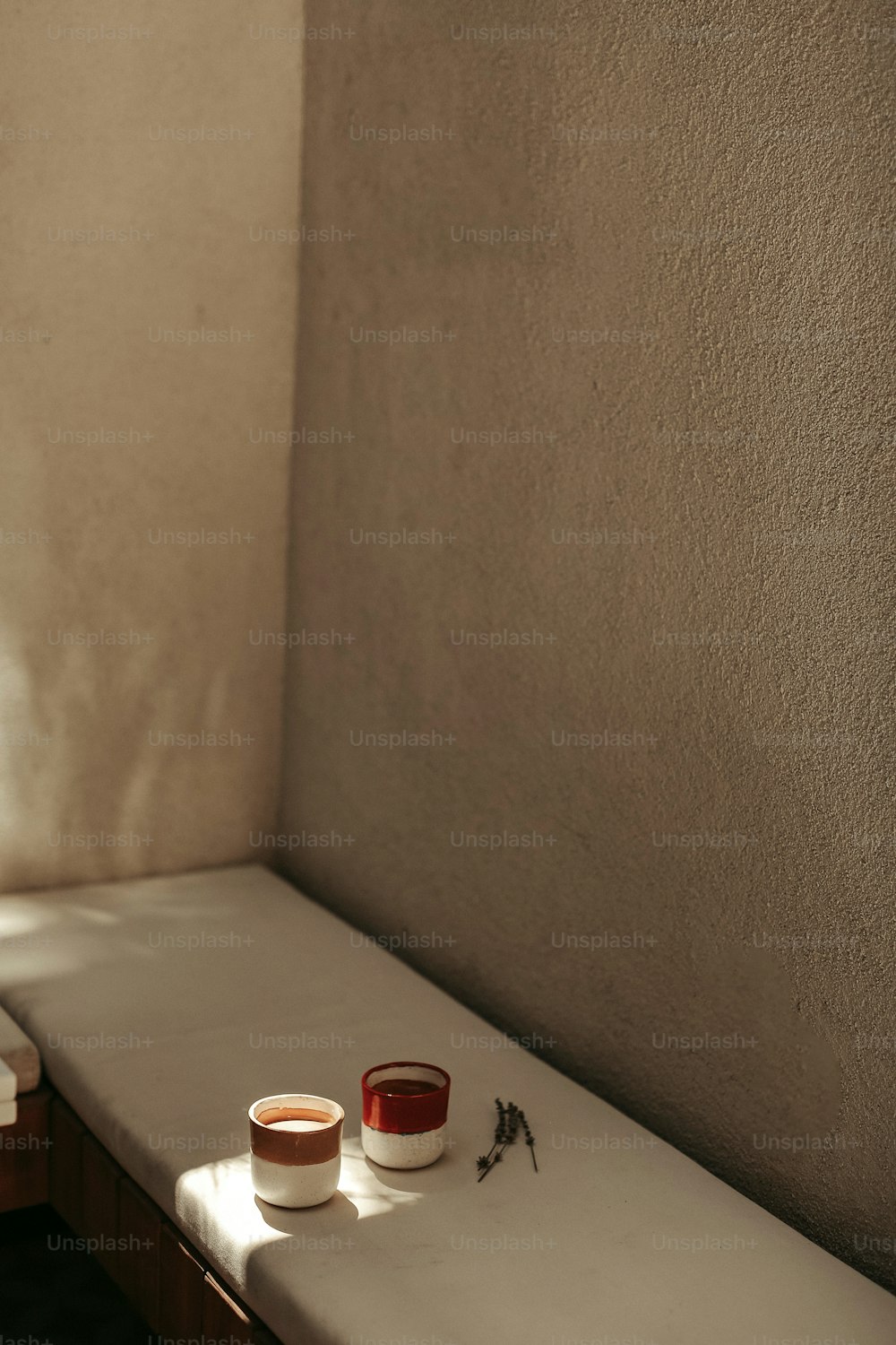 a couple of cups sitting on top of a white counter