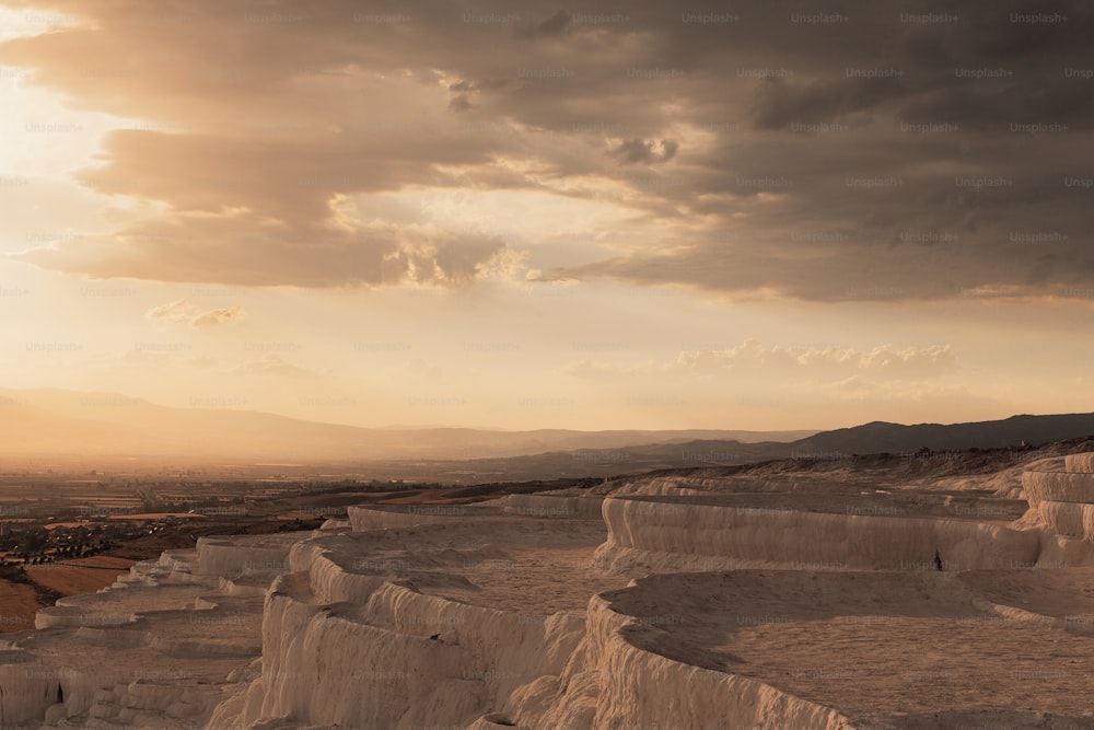 the sun is setting over the desert landscape