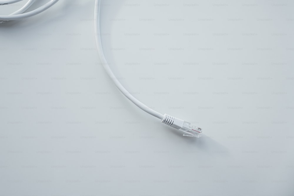 a close up of a white cord on a white surface