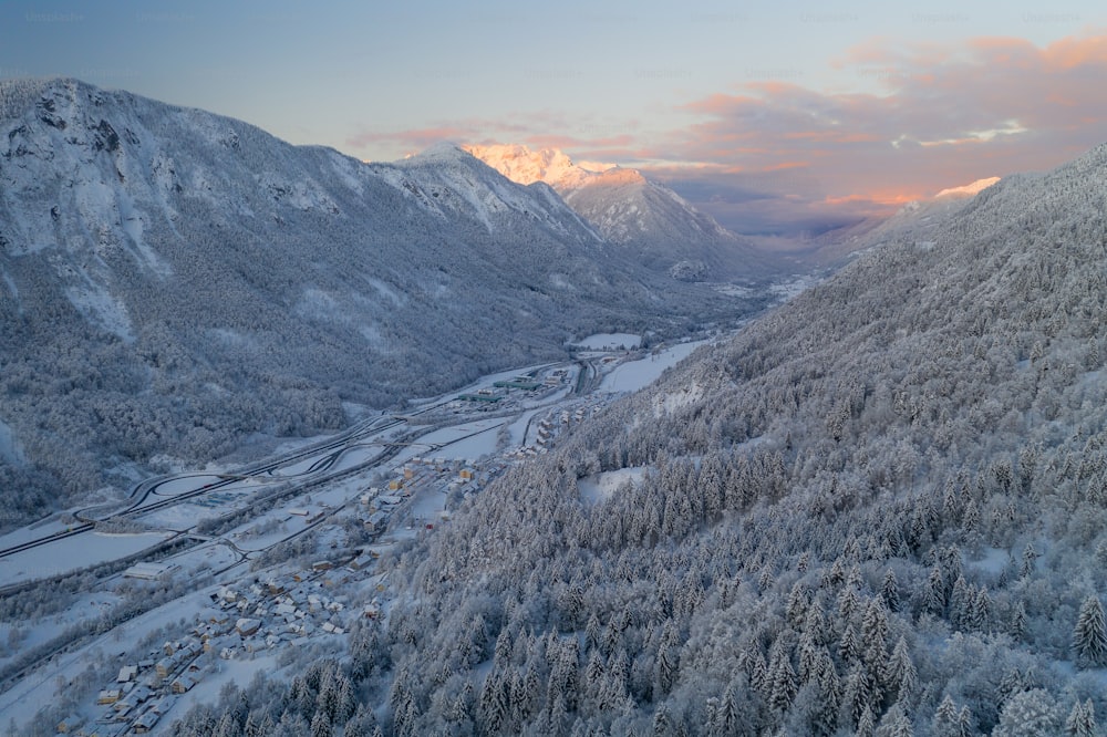 an aerial view of a snowy mountain valley