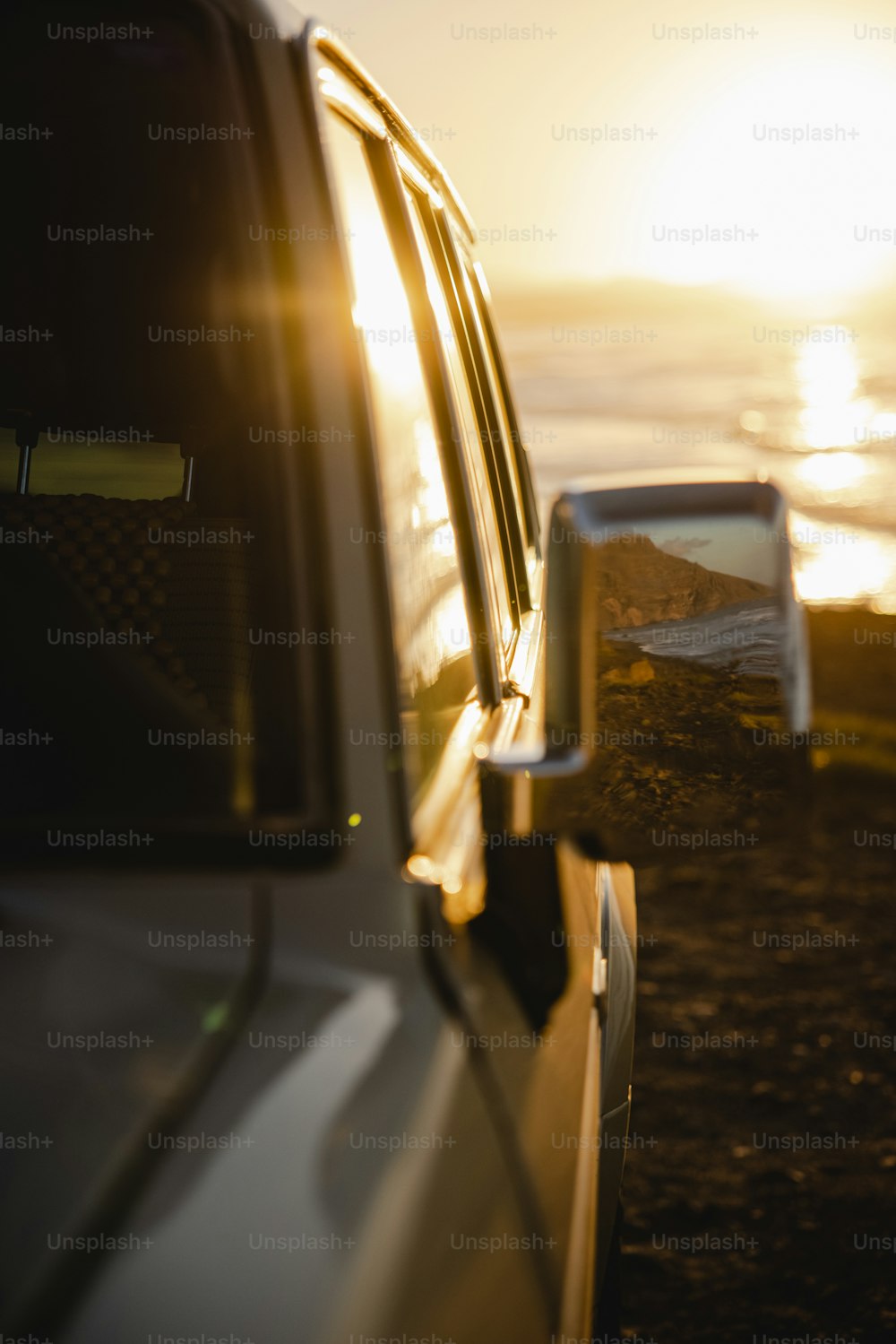 a car parked on the side of the road near the ocean