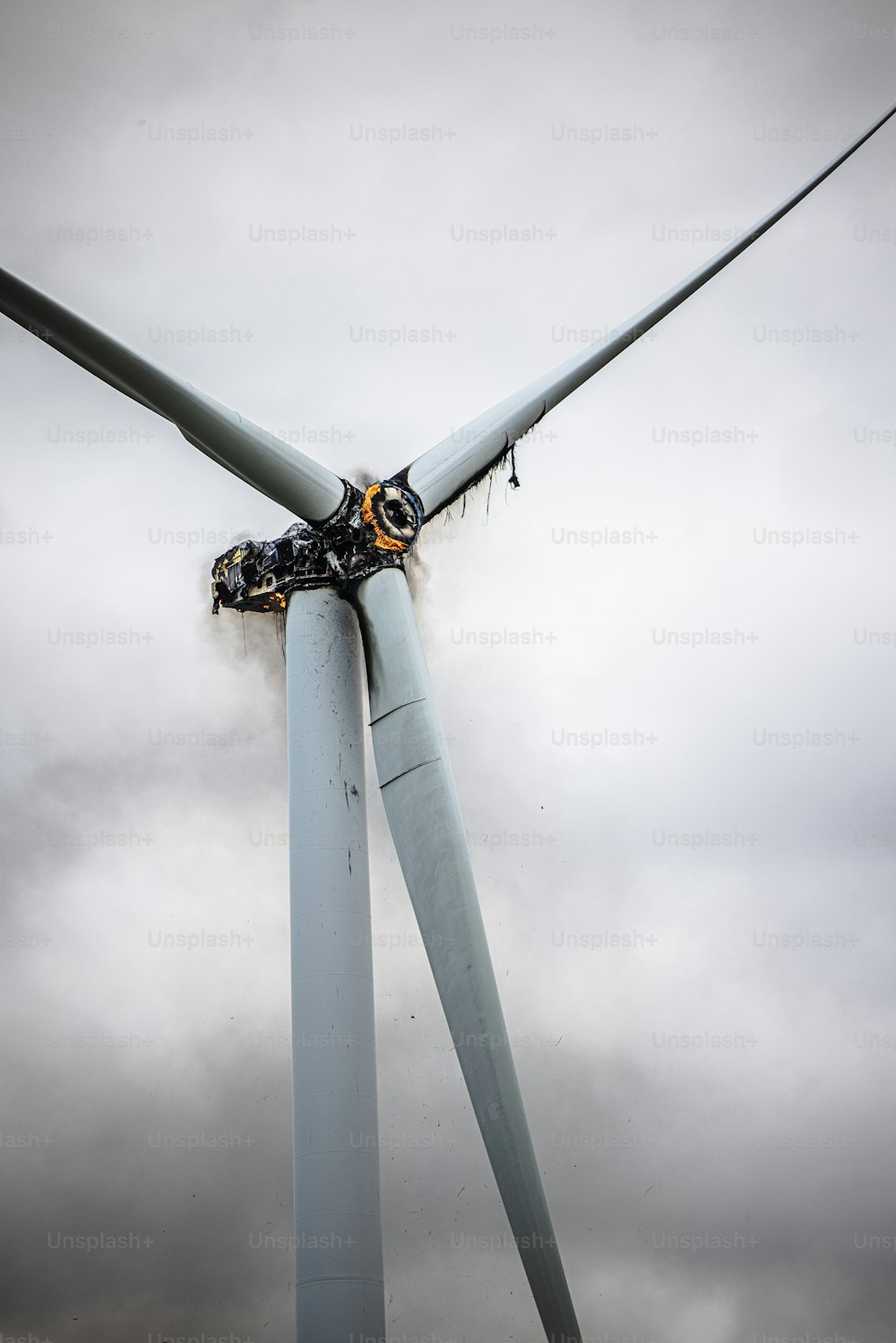 a wind turbine with a man working on it