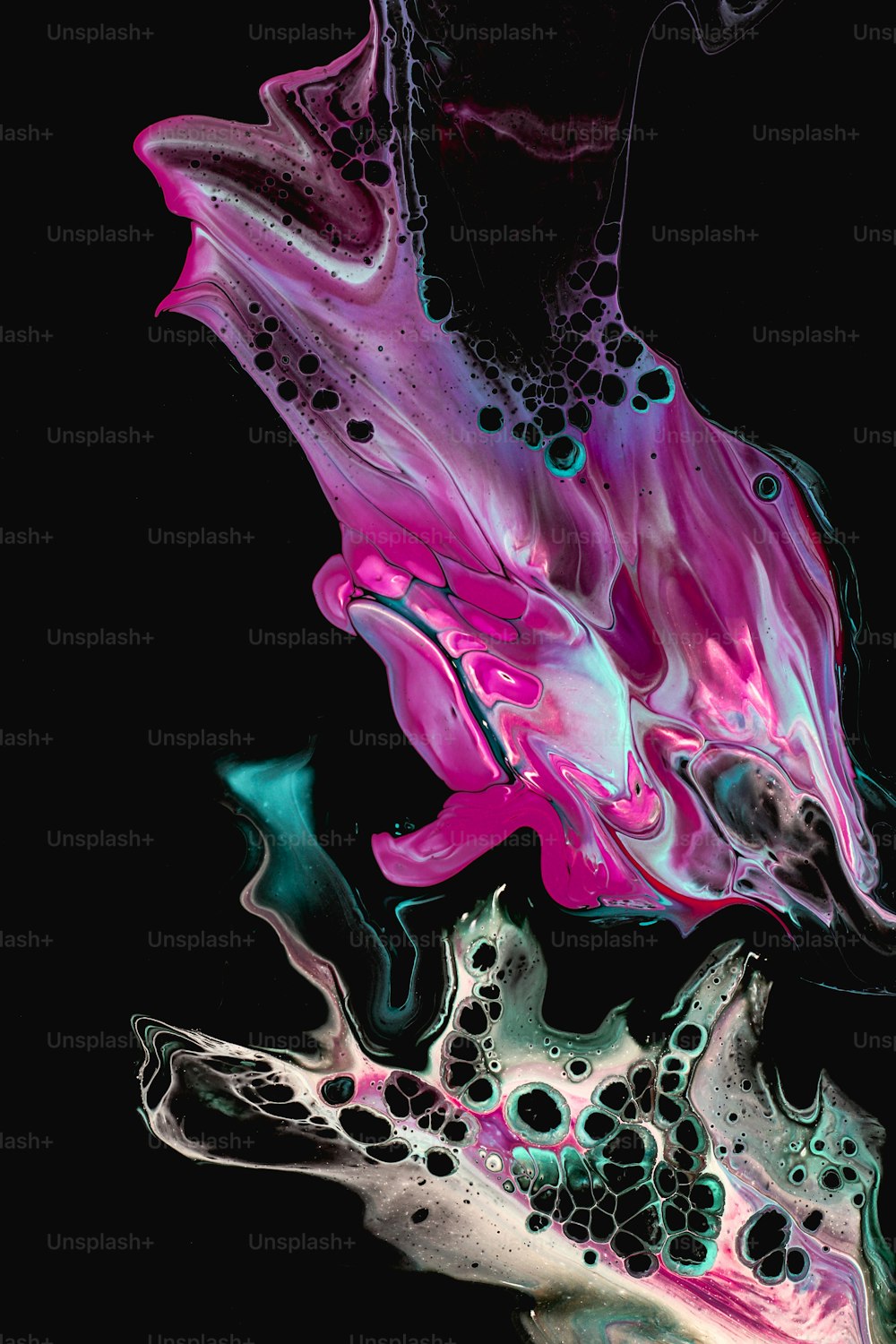 a black background with a pink and blue substance