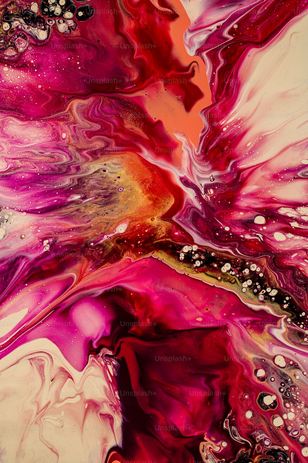 a close up of a liquid painting on a white surface