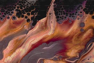a close up of a black background with orange and pink swirls