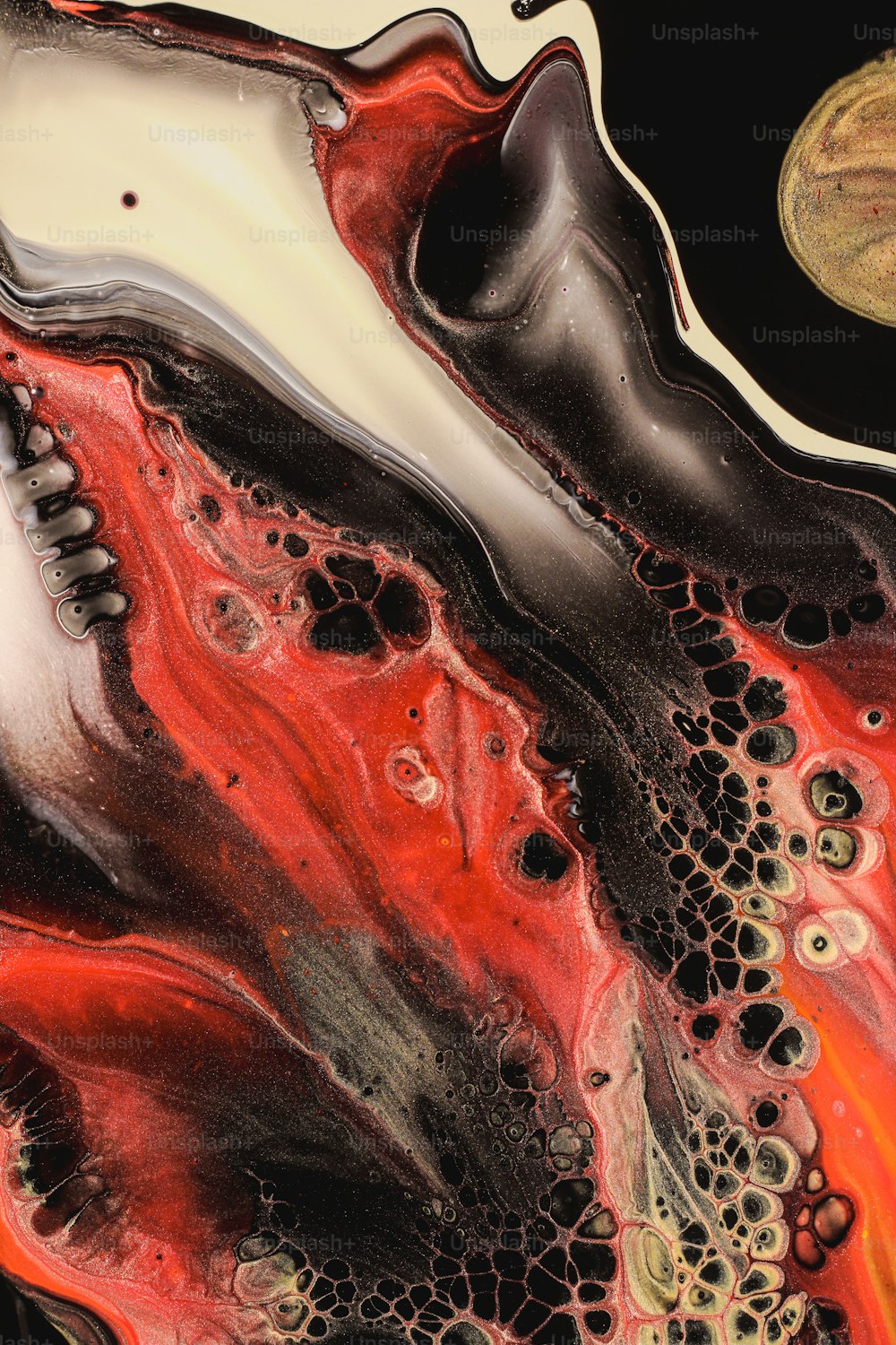 a close up of a red and black liquid