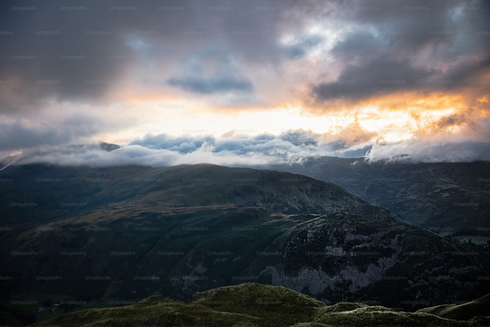 a view of a mountain range with clouds in the sky