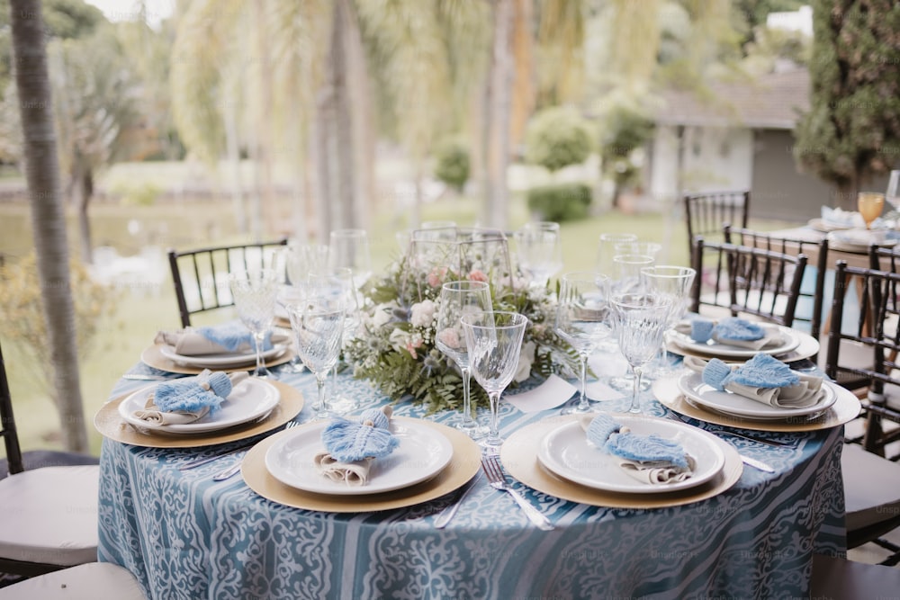 Una mesa puesta para una cena formal afuera