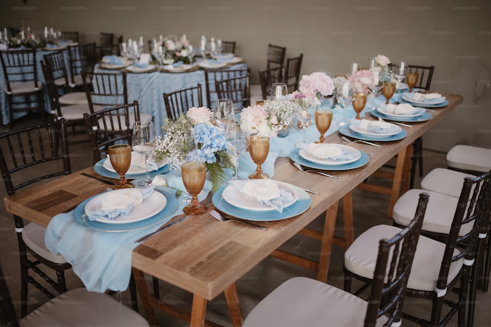 a table set with blue and white plates and silverware