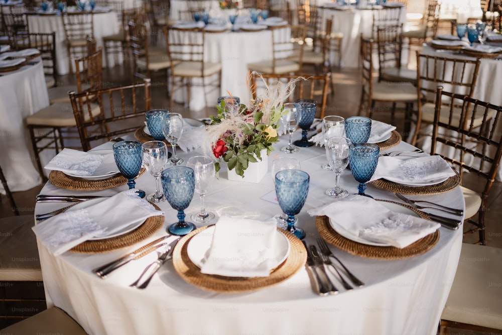 a table set with blue and white plates and silverware