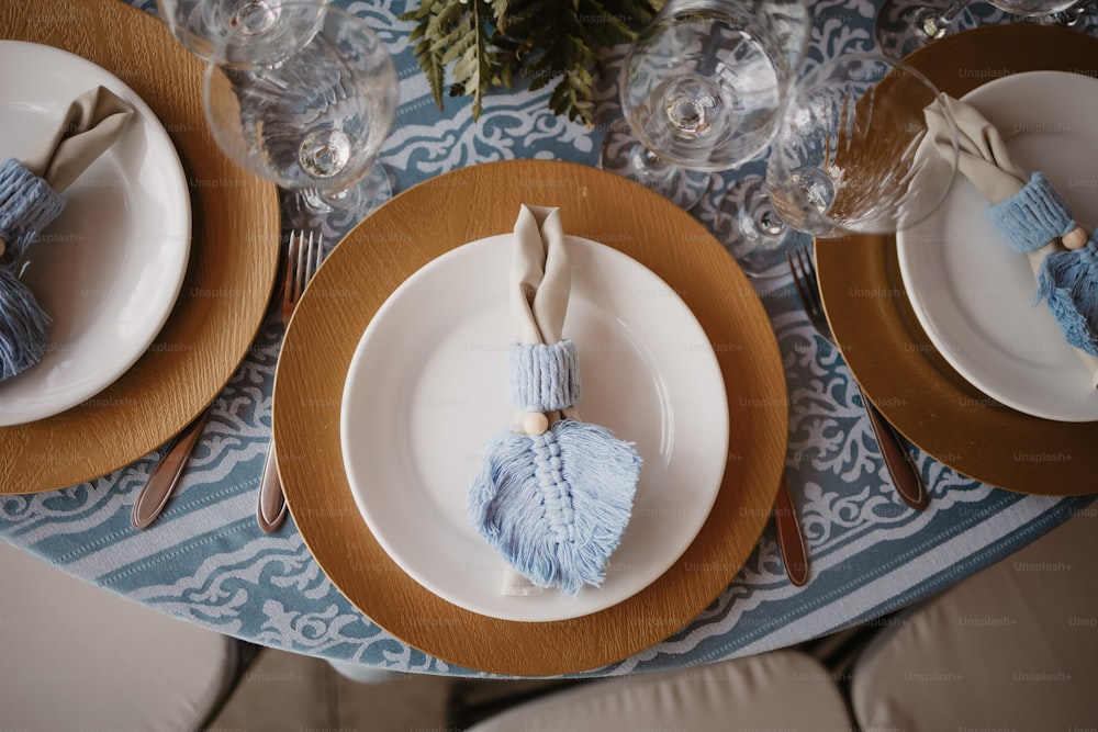 a close up of a table with plates and place settings