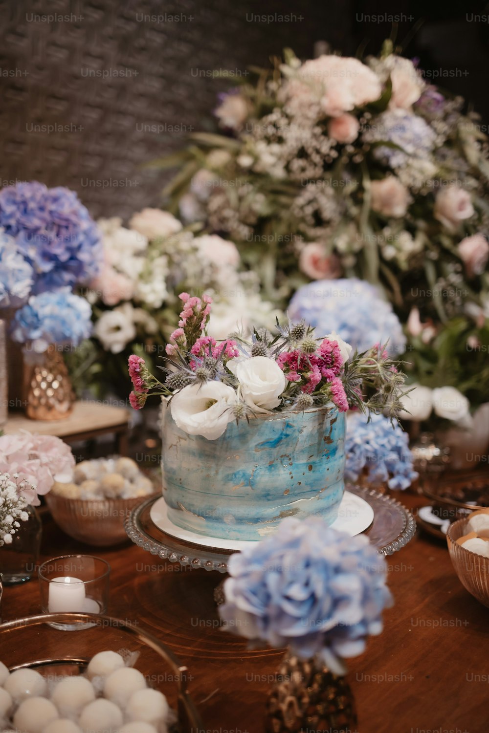 a blue and white cake sitting on top of a wooden table