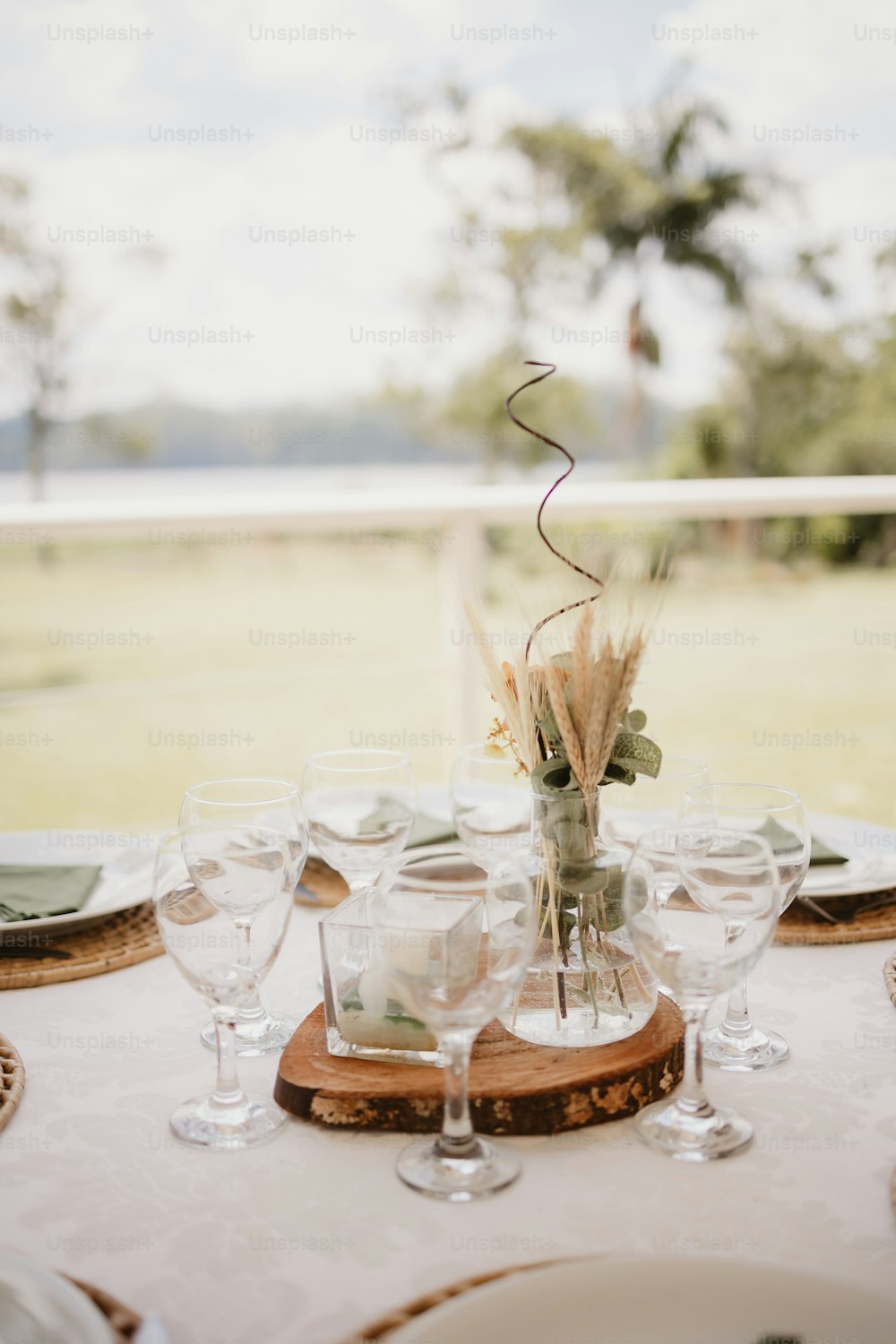 a table is set with wine glasses and plates