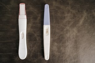 two toothbrushes sitting next to each other on a table