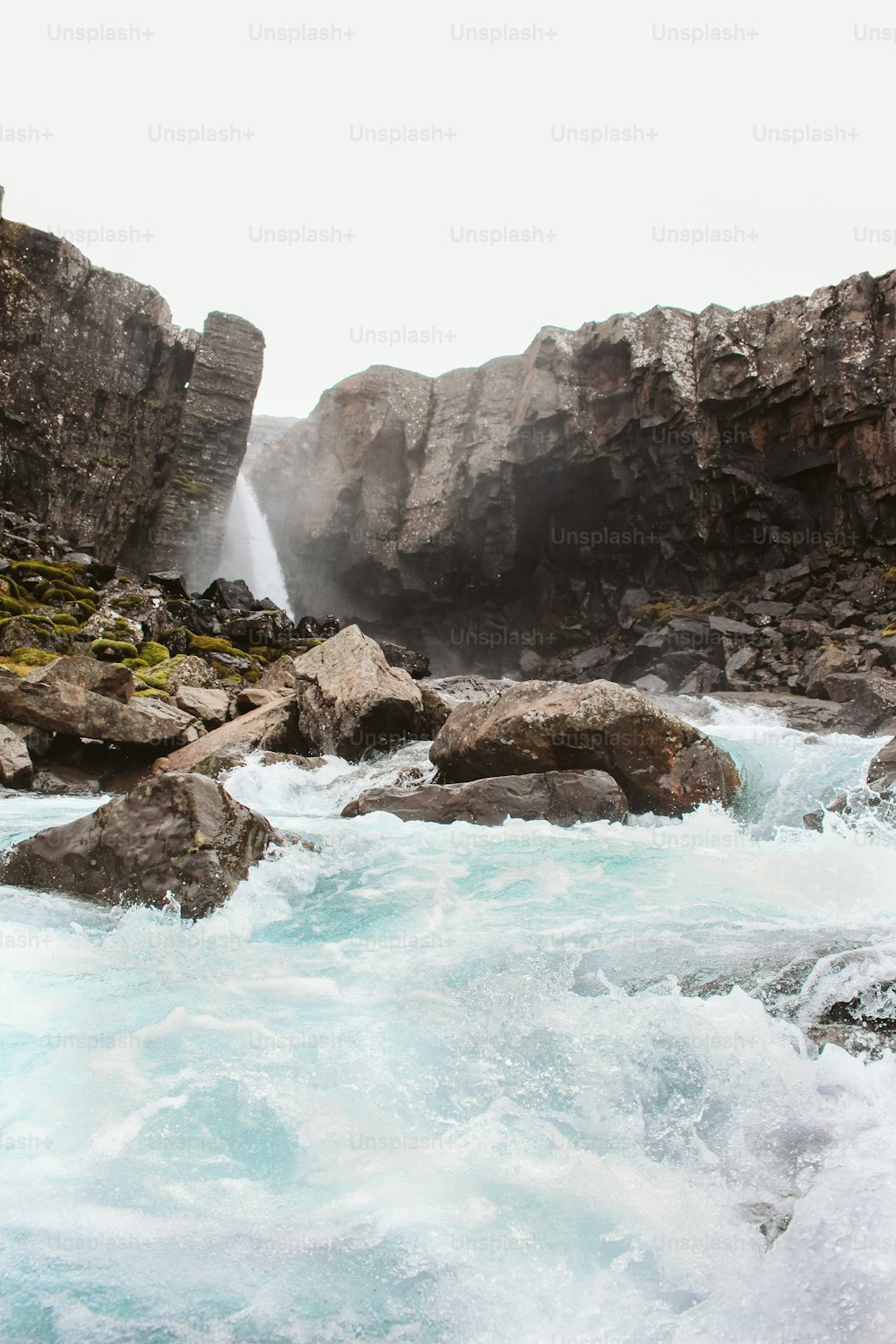 a man standing on a rock in the middle of a river