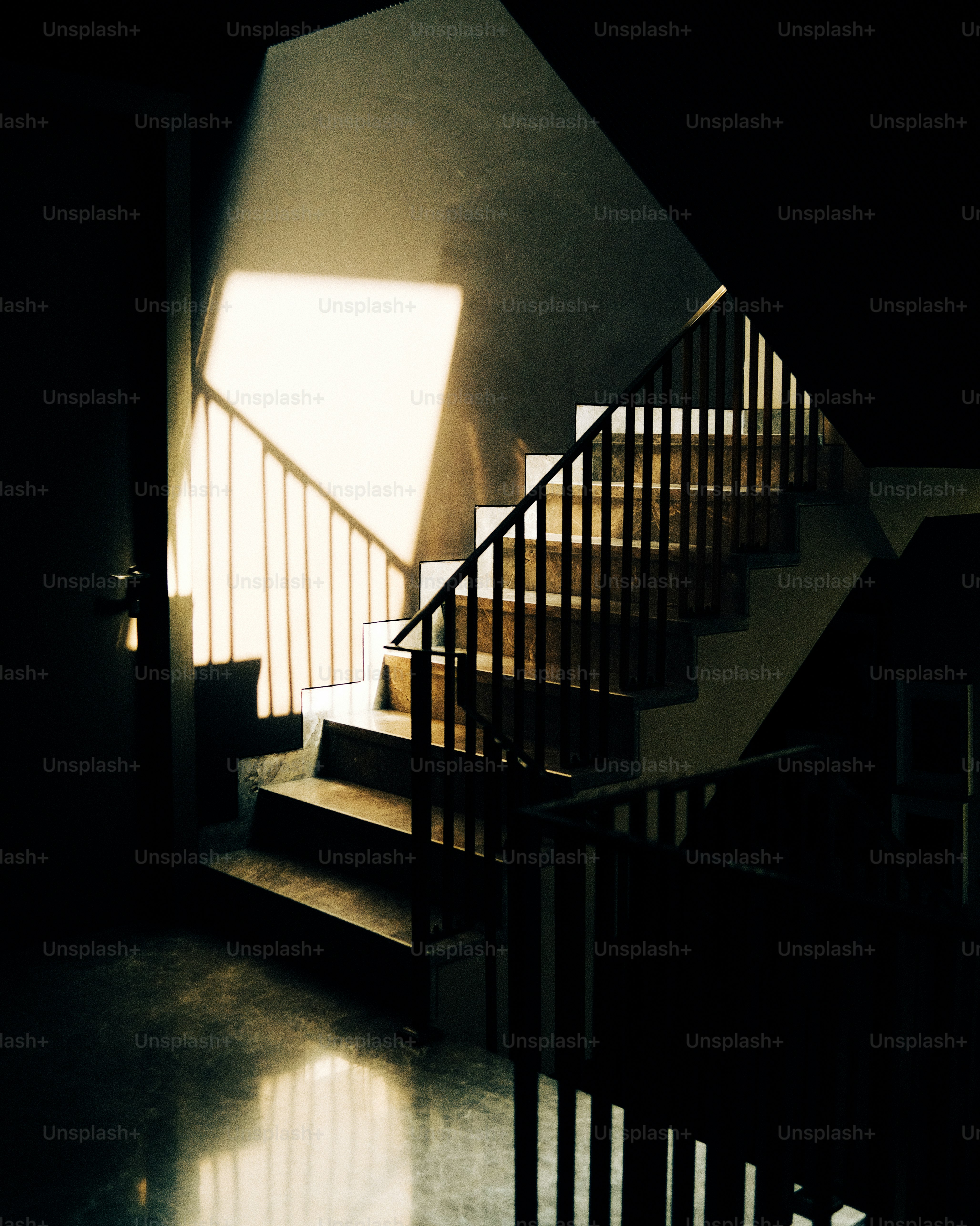 a stair case with a light coming through the window