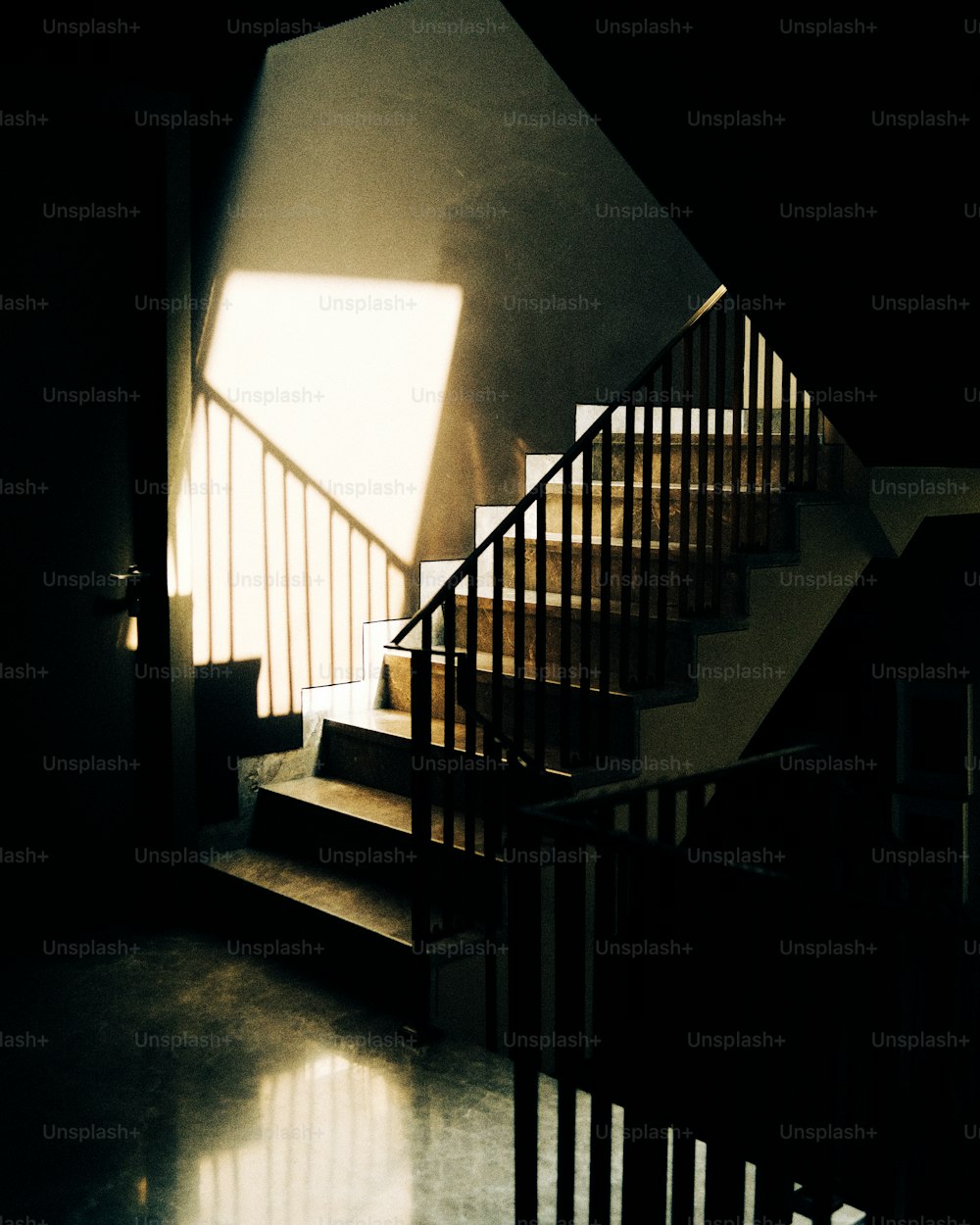 a stair case with a light coming through the window